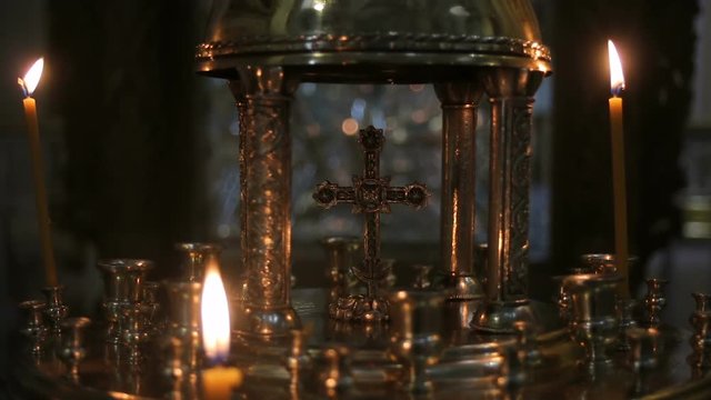 candles standing in the Golden candlestick of the cross in the Church