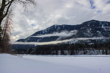low hanging clouds and overcast during the winter over the Fraser River, Hope British Columbia, Canada