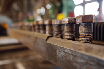 Production of bolts against the background of the plant. Heavy industry, plant, metal structures