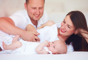 Fototapeta na wymiar happy young parent enjoying communication with cute infant baby