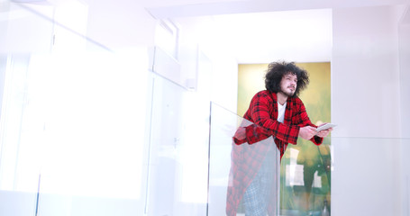 young man using a tablet at home