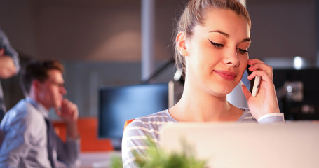 woman using mobile phone in dark office