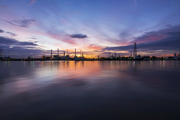 Fototapeta na wymiar Oil refinery or petrochemical industry with ship at Sunset with water reflection in thailand. for Logistic Import Export background, Petroleum, petrochemical plant.