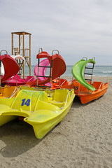 colorful pedalo paddle boat on the sandy beach