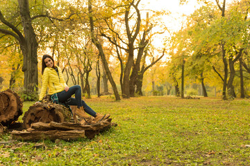 Naklejka na ściany i meble Woman enjoying the autumn in the forest 