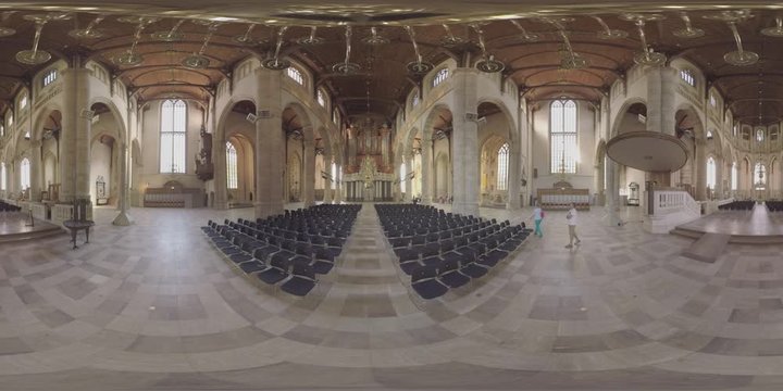ROTTERDAM, NETHERLANDS - AUGUST 07, 2016: 360 VR video. Interior of medieval St. Lawrence Church built between 1449 and 1525. View to the hall with empty chairs, pipe organ and grand columns. Man