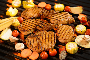 Grilled meat /steak with vegetable on the flaming grill
