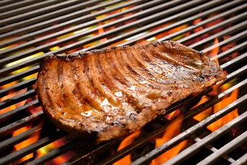 Foto op Canvas Grilled pork ribs/steak on the flaming grilled © amenic181