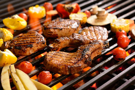 Grilled meat /steak with vegetable on the flaming grill