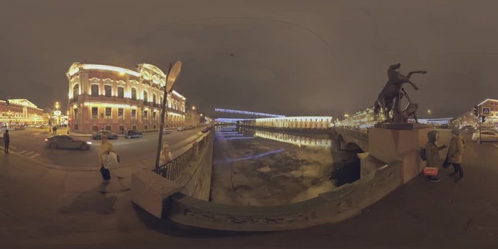 SAINT PETERSBURG, RUSSIA- JANUARY 02, 2017: 360 VR video. Night city with view of Nevsky Prospect and Anichkov Bridge so as of Fontanka River waterfront. Illuminated buildings, people crossing the