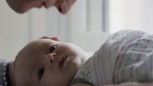 Close up slow motion shot of father caressing baby daughter / Provo, Utah, United States
