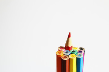 Set of colored pencils with a single sharp one symbolizing leadership concept