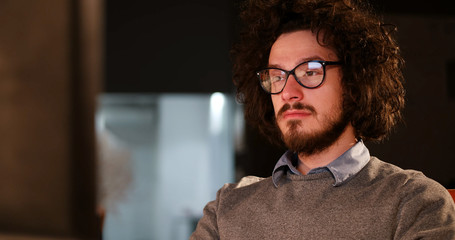man working on computer in dark office