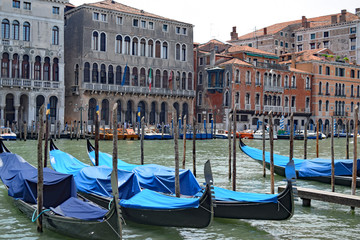 Fototapeta na wymiar Gondolas docked near Santa Maria train station, on the Grand Canal in Venice, Italy
