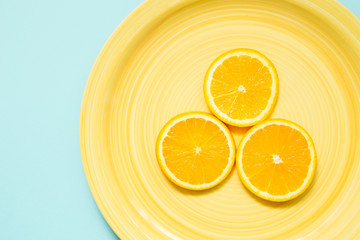 fresh orange on yellow plate