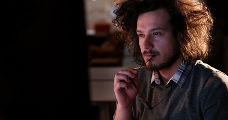 man working on computer in dark office