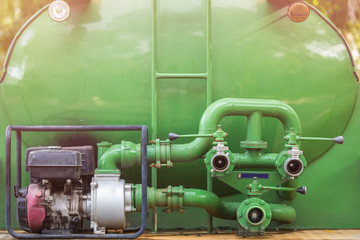 Obraz premium Green fire truck hose connectors or water pump with connectors for spray to garden