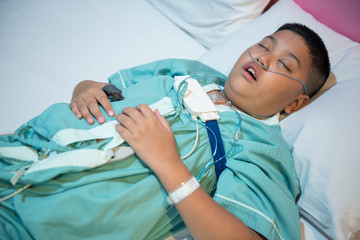 Asian boy wearing Sleep Apnea Diagnostic medical device Kit. Sleep Lab Test.
