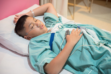 Asian boy wearing Sleep Apnea Diagnostic medical device Kit. Sleep Lab Test. - 164782797