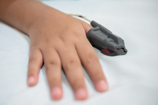 Hand of Asian boy wearing Sleep Apnea Diagnostic medical device Kit. Sleep Lab Test.