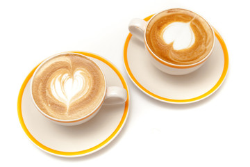 Coffee cups of latte art heart shape on white background isolated