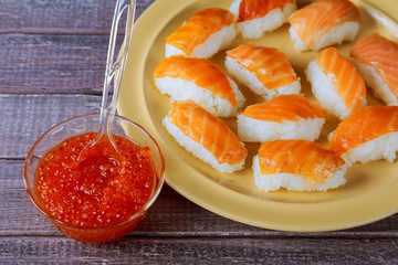 Salmon sushi nigiri over wood background