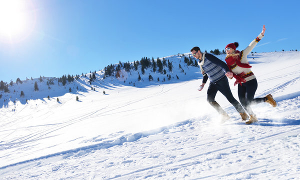 Cheerful young couple having fun in winter park