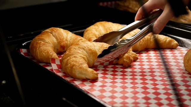 Motion of woman buying croissants bread inside buy low foods store
