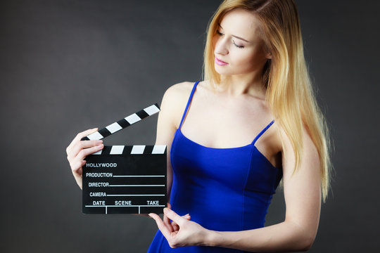 Woman holding professional film slate