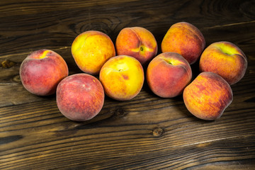 Fototapeta na wymiar Ripe peaches on wooden table