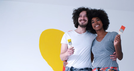 couple with painted heart on wall