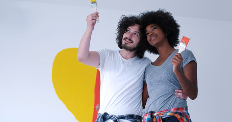 couple with painted heart on wall