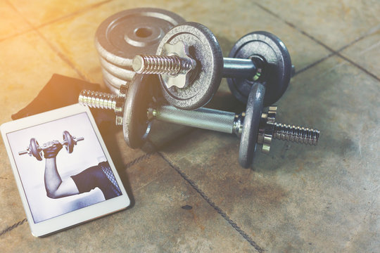 Iron Dumbbells With Adjust Iron Weight Plate With White Tablet For Watching Online Training For Workout At Home.