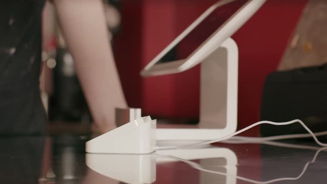 Close up shot of customer paying cashier with credit card / Salt Lake City, Utah, United States
