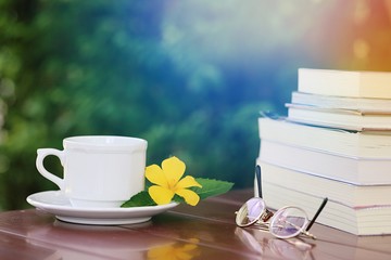 Open books and white coffee cup closeup on table. Books and coffee concept relaxation at home