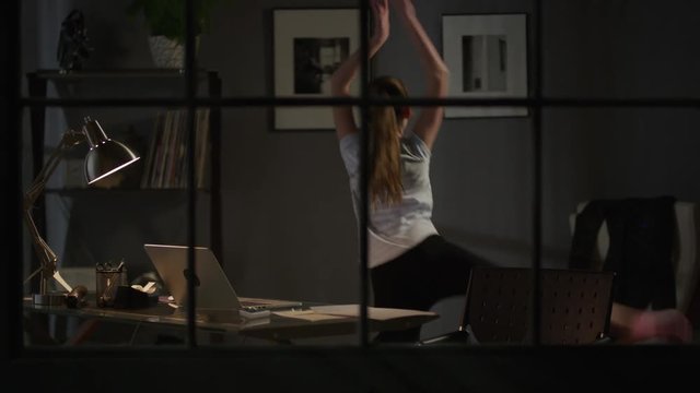 Medium zoom out shot of girl dancing to music on laptop / Cedar Hills, Utah, United States