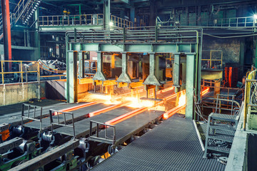 hot steel on conveyor in steel plant - Powered by Adobe