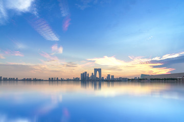 River And Modern Buildings Against Sky at twilight in city of China.