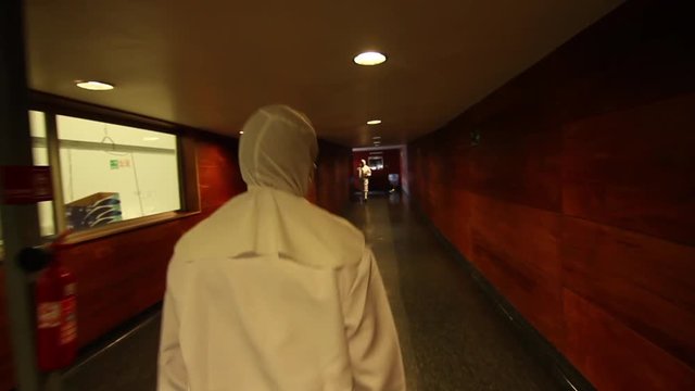 Worker walking through corridor in suit