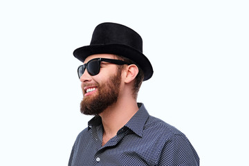 Fototapeta na wymiar Bearded hipster male in sunglasses and cylinder hat.