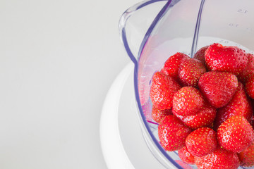 Fresh red strawberries are ready for shaking in the blender for making smoothie. Healthy eating.
