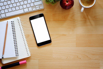 Office desktop with office accessories, Wood table with business objects and snack foods. Blank screen smartphone for text ,graphic or products display montage.
