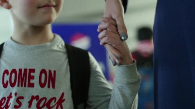 Airhostess holding child's hand