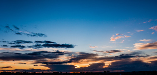 city skyline at dawn, the outlines of houses in the backlight,