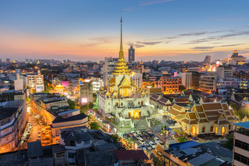 Aerial view cityscape twilight of Wat Trimit Witthayaram Worawihan and chinatown or yaowarat area, Temple of the Golden Buddha in Bangkok, Thailand.