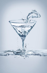 A fish jumping out glass of a martini glass made of water.