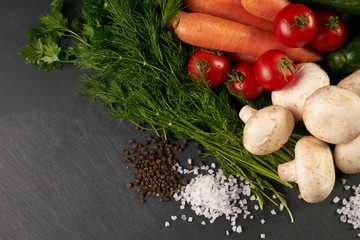 Close-up of a fresh delicious ingredients for healthy cooking or salad making on rustic background, top view, banner. Diet or vegetarian food concept.