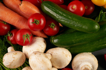 Top view of a raw vegetables. View from above of a Fresh vegetable. Colorful vegetables background. Healthy vegetable studio photo. Assortment of fresh vegetables on dark stone kitchen table.