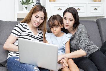 Happy family woman and kid using laptop at home, happy family concept, 3 person
