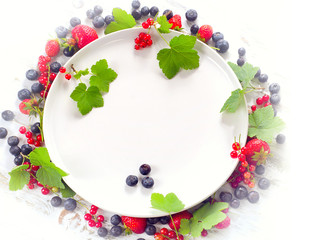 Various fresh summer berries - blueberries, strawberries and red currant. Healthy eating concept.